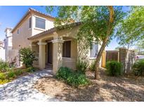 Charming home featuring a covered porch with a landscaped front yard and shade tree at 3837 E Santa Fe Ln, Gilbert, AZ 85297