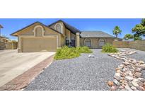 Charming single-Gathering home featuring a well-maintained yard and a two-car garage, offering curb appeal at 5424 E Florian Ave, Mesa, AZ 85206