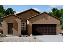 Lovely tan stucco home with dark brown garage door and arched entryway at 5782 E Orion Rd, Florence, AZ 85132
