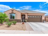 Charming single-story home featuring a well-maintained front yard and a two-car garage at 729 W Silver Reef Dr, Casa Grande, AZ 85122