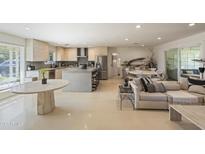 Open-concept living space featuring a kitchen, dining area, and comfortable seating at 7719 N 17Th Ave, Phoenix, AZ 85021