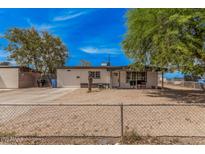 Charming single-story home featuring a low fence and gravel landscaping for easy maintenance at 7746 W Osborn Rd, Phoenix, AZ 85033