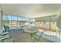 Relaxing screened patio with outdoor furniture and a view of the community at 111 S Greenfield Rd # 467, Mesa, AZ 85206