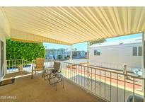 Covered patio with outdoor seating, offering a pleasant space for relaxation and enjoying the community views at 111 S Greenfield Rd # 531, Mesa, AZ 85206