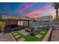 Inviting backyard featuring a cozy fire pit, pool, and a covered patio, ideal for outdoor living and entertaining at 11252 E Edgewood Ave, Mesa, AZ 85208