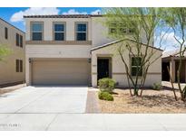 Charming two-story home featuring a front yard, a two-car garage and a welcoming entrance at 12531 W Glenn Dr, Glendale, AZ 85307