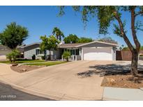 Well-maintained single-story home featuring a wide driveway and charming curb appeal at 1311 W Ellis St, Mesa, AZ 85201