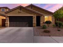 Charming single-story home with a well-manicured front yard, driveway, and a two-car garage at 2023 W Yellowbird Ln, Phoenix, AZ 85085