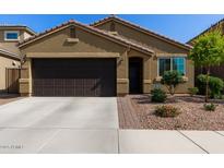 Charming single-story home with a desert-landscaped front yard and two-car garage at 2023 W Yellowbird Ln, Phoenix, AZ 85085