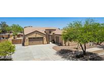 Inviting single-Gathering home with a three-car garage, desert landscaping, and a covered patio in a sunny neighborhood at 21284 E Camacho Rd, Queen Creek, AZ 85142