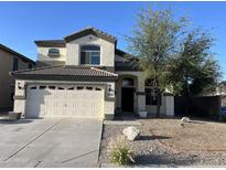 Charming two-story home with a two-car garage and desert landscaping at 24919 W Illini St, Buckeye, AZ 85326