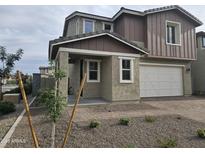 Two-story home with a two car garage and a charming covered entrance and neutral colored gravel landscaping at 3390 S 180Th Ln, Goodyear, AZ 85338