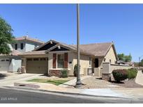 Charming single-story home with desert landscaping, a tile roof and an attached two-car garage at 3558 E Windsor Dr, Gilbert, AZ 85296