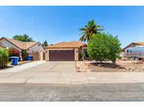 Charming single-story home featuring a well-maintained yard, desert landscaping, and a spacious driveway at 3608 W Morelos St, Chandler, AZ 85226