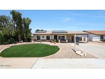 Charming single-story home with a well-manicured front yard and solar panels at 730 W Curry St, Chandler, AZ 85225