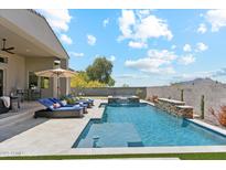 Inviting backyard oasis with a sparkling pool, spa, and lounge chairs for ultimate relaxation at 8396 E Granite Pass Rd, Scottsdale, AZ 85266