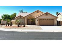Charming single-story home with desert landscaping, a two-car garage, and a welcoming front entrance at 9109 W Watson Ln, Peoria, AZ 85381