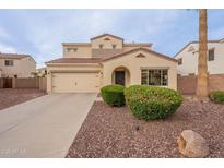 Charming two-story home featuring a two-car garage, well-maintained landscaping, and a red-tile roof at 13318 W Indianola Ave, Litchfield Park, AZ 85340