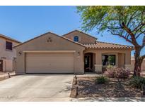 Charming single-story home featuring a two-car garage, tile roof, and a well-manicured front yard with desert landscaping at 16219 W Yucatan Dr, Surprise, AZ 85379