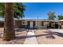 Charming single-story home with a well-maintained gravel yard and covered parking area at 1628 E Sunland Ave, Phoenix, AZ 85040