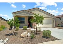 Inviting single-story home featuring a two-car garage and charming desert landscaping at 18032 W Muirwood Dr, Goodyear, AZ 85338