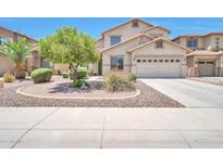 Charming two-story home featuring a desert landscaped front yard and a two-car garage at 18118 N Smith Dr, Maricopa, AZ 85139