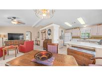 Inviting living room featuring neutral walls, modern ceiling fan, and built-in shelving at 2400 E Baseline Ave # 197, Apache Junction, AZ 85119