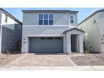 Charming two-story home features a two-car garage and nicely landscaped front yard at 2482 W Rowel Rd, Phoenix, AZ 85085