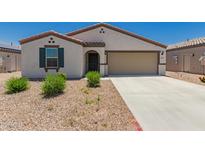 Inviting single-story home featuring a two-car garage, neutral stucco, a desert landscape, and a charming covered entry at 25539 W Gwen St, Buckeye, AZ 85326