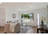 Inviting living room with modern decor, lots of natural light, and hardwood floors at 3707 E Amelia Ave, Phoenix, AZ 85018