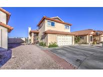 Charming two-story home features a red tile roof, tan stucco, and a two-car garage at 4545 N 67Th Ave # 1101, Phoenix, AZ 85033