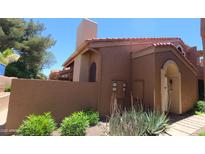 Charming home exterior with stucco walls, red tile roof, and desert landscaping at 5640 E Bell Rd # 1047, Scottsdale, AZ 85254