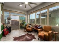Bright sunroom featuring tile floors, ceiling fan, and lots of windows at 5897 N 195Th Dr, Litchfield Park, AZ 85340