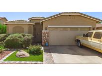 Charming single-Gathering home with a two-car garage, lush landscaping, and stone accents at 6620 S 16Th Dr, Phoenix, AZ 85041