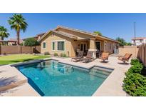 Inviting backyard pool with lounge chairs, putting green, and lush landscaping creating a relaxing outdoor oasis at 7050 S Fawn Ave, Gilbert, AZ 85298