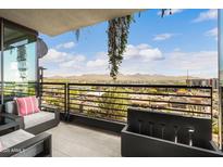 Relaxing balcony area with comfortable seating and a view of the city and mountains at 7180 E Kierland Blvd # 811, Scottsdale, AZ 85254