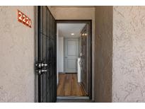 Inviting entryway with a security door and view of the light hardwood flooring inside at 7430 E Chaparral Rd # A222, Scottsdale, AZ 85250