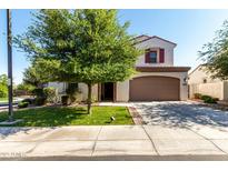 Charming two-story home featuring desert landscaping, a spacious driveway, and a two-car garage at 919 W Yellowstone Way, Chandler, AZ 85248