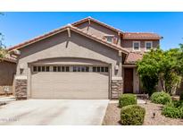 Charming two-story home featuring a neutral color palette, tile roof, well manicured landscaping, and attached two car garage at 932 W Capulin Trl, San Tan Valley, AZ 85140