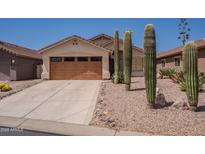 Single-story home featuring a desert landscape, a two-car garage, and a neutral color palette at 10346 E Desert Dawn Dr, Gold Canyon, AZ 85118