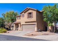 Charming two-story home featuring a neutral color scheme, attached two-car garage, and well-maintained landscaping at 1145 E Lowell Ave, Gilbert, AZ 85295