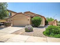 Charming single-story home with a two-car garage, desert landscaping, and a well-maintained front yard at 12441 W Windsor Blvd, Litchfield Park, AZ 85340