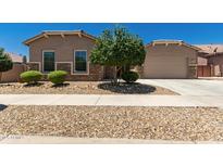 Charming single-story home with desert landscaping, stone accents, and a two-car garage at 16785 W Montana De Oro Dr, Surprise, AZ 85387