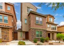 Stylish multi-story home with stone accents, desert landscaping, and charming curb appeal at 2031 N 77Th Ln, Phoenix, AZ 85035