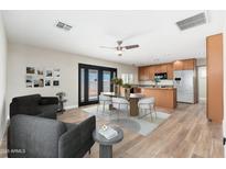 Open-concept living space with a dining area, stylish furniture, and wood-look flooring at 2941 W Michigan Ave, Phoenix, AZ 85053