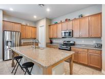 Spacious kitchen island with granite countertops and stainless steel appliances provides plenty of cooking space at 4630 E Navigator Ln, Phoenix, AZ 85050