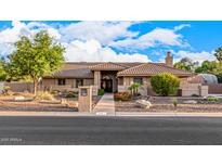 Beautiful single-story home featuring desert landscaping and a tile roof at 5861 E Anderson Dr, Scottsdale, AZ 85254