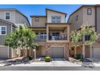 Inviting two-story townhome featuring a private balcony and a brick-accented garage at 631 W Winchester Dr, Chandler, AZ 85286