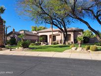 Charming single-story home with a beautifully landscaped front yard and mature trees at 6428 W Eugie Ave, Glendale, AZ 85304