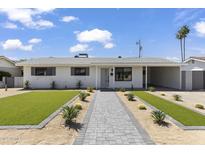 Charming home featuring a well-manicured front yard and a welcoming walkway at 6723 E 1St Ave, Scottsdale, AZ 85251